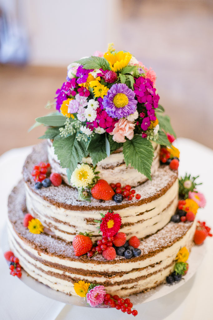 Traumhafte Hochzeitstorte mit Blumendekoration | Strauß & Fliege