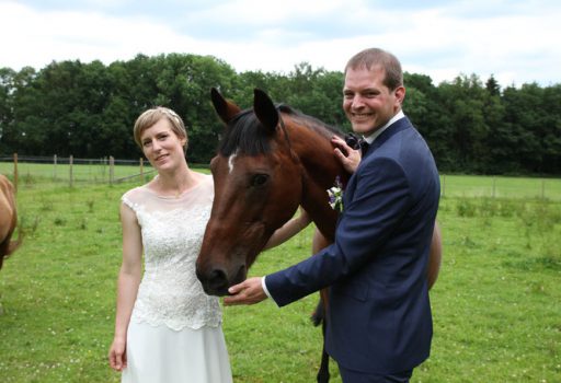 Brautpaar mit Pferd bei DIY Hochzeit in einer Scheune